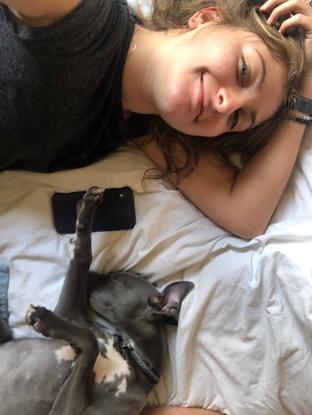 Laura has naptime with four month old whippet puppy Monty